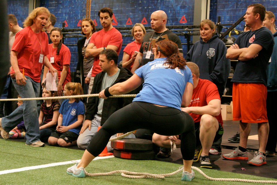 female first responder athlete pulling weighted sled